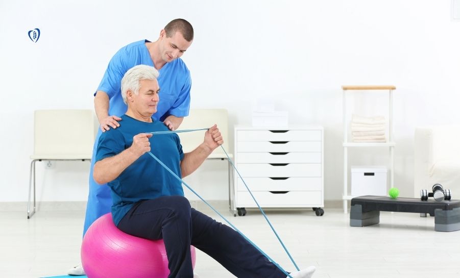A physiotherapist coaching a resistance band exercise